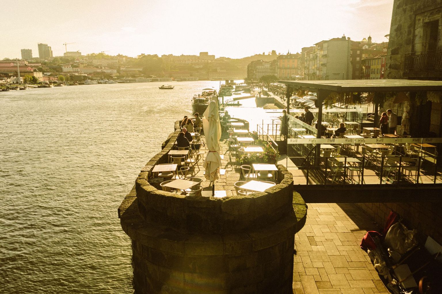 Waterfront restaurant deck in Naples at sunset with boats tied alongside